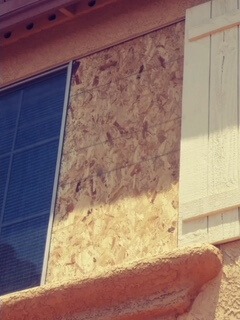 broken window boarded up for replacement