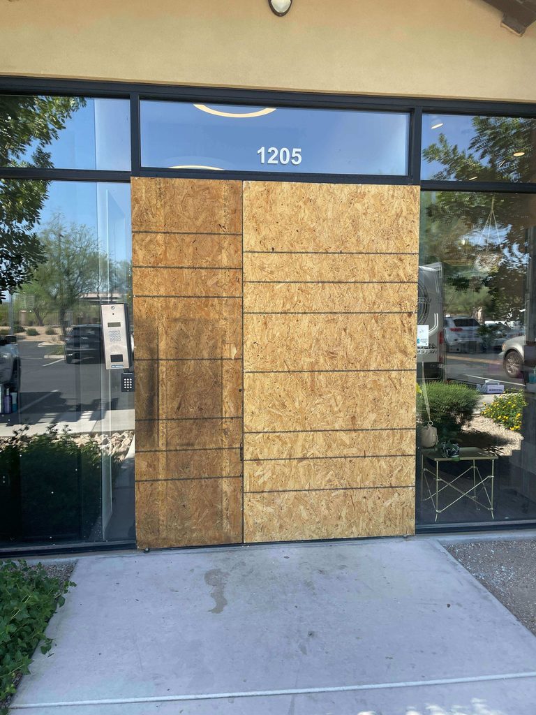 board up of broken storefront doors